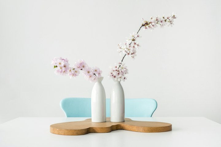 Flowering branches in ceramic vases on a table