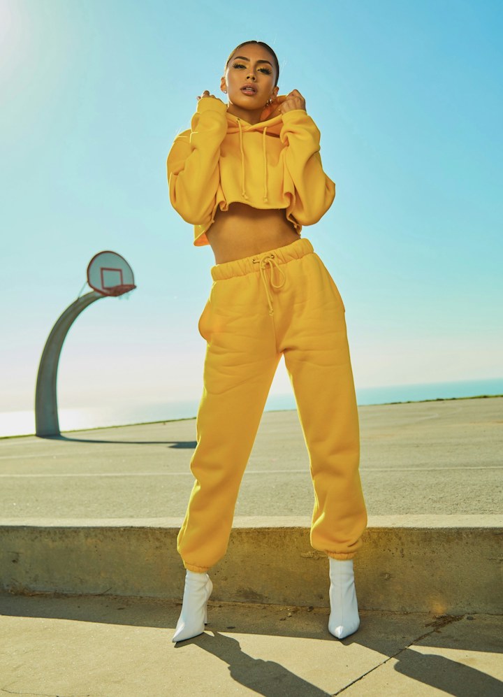 A model wearing a yellow outfit in the sunshine