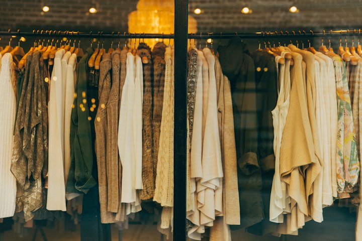 Neutral clothing hanging on a boutique rack